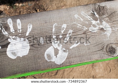 white hands paint prints on wood 