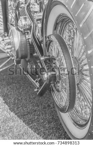 black and white, rear wheel and engine of a vintage motorcycle