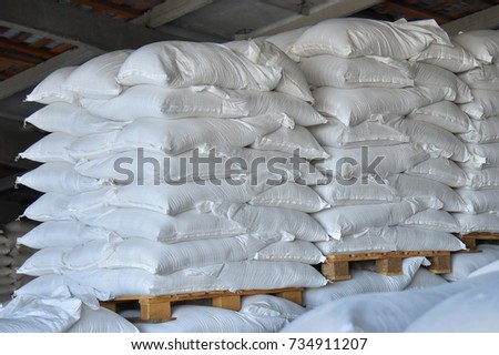Many stacked bags of sugar, for the further sending in the factory plant