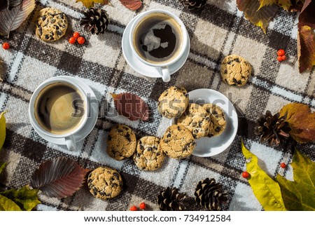 Cookies, coffee cups and pine cones view from above close