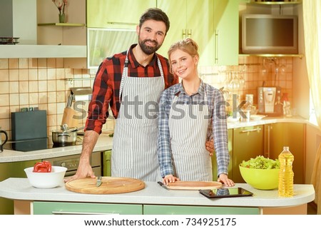 Man and woman smiling, kitchen. Happy caucasian couple.