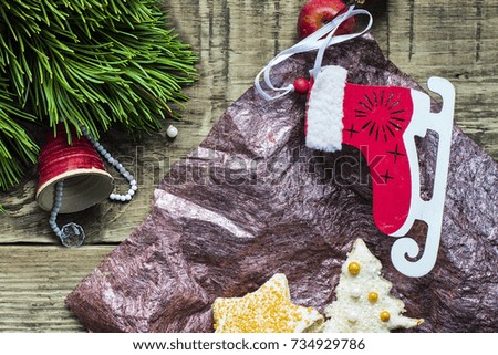 Christmas fir tree with decoration on dark wooden board.Christmas motifs