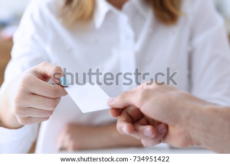Female hand in suit give blank calling card to female visitor closeup. White collar partners company name exchange executive or ceo introducing at conference product consultant sale clerk concept