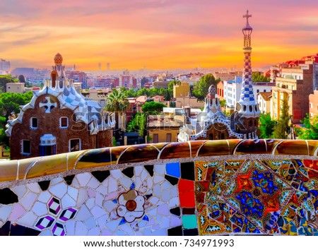 Sunrise famous summer Park Guell designed by Antoni Gaudi located on Carmel Hill, bench covered with tile-shard mosaic, Barcelona, Spain.