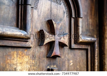 Old wooden door with Maltese crosses close-up