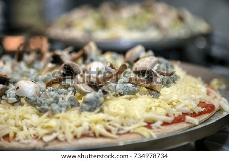 A low-carb mushroom pizza with gorgonzola and mozzarella cheese for dinner. Gluten free. Gastronomy. Cuisine. Cooking. Art. Natural food.