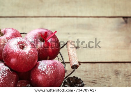 Red apples on a rustic wooden background. Christmas mood. Horizontal, space for text