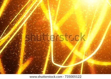 Xmas Gold sparkles or glitter lights. Christmas festive golden background. Defocused lines bokeh or particles. Template for design
