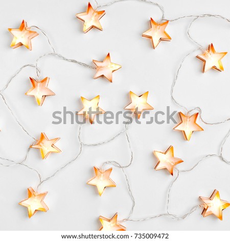 Star shaped Christmas lights. Holiday pattern. Flat lay, top view