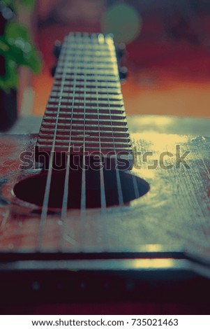 A fragment of the guitar background. Photo retro stylized. Music and art concept.