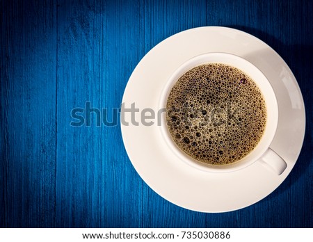 Over view of coffee on blue wooden background with dramatic vignetting