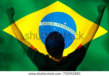 The football player in moments action  in Brazil flag. Mixed media for sports background.
The Roman letter is capitalized in green "Ordem e Progresso"  the meaning is  Regulation and  progress .