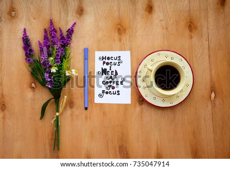 Coffee cup and hocus pocus i need a coffee to focus text on a note on wooden table with lavender flowers