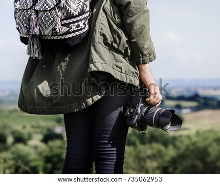 Woman with camera in the nature