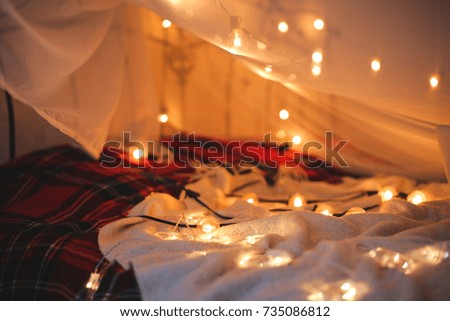 the laptop lies on the bed in the background of a Christmas-tree light,smooth movement