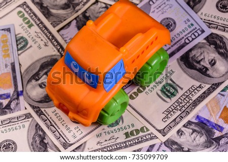 Toy car on one hundred dollar bills