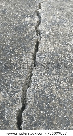 cracked concrete wall covered with gray cement surface as background

