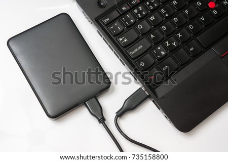 External hard disk (HDD) connected to laptop computer by USB cable
