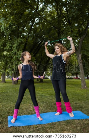 Teamwork family gymnastics. Active sport outdoors. Yoga training exercise, healthy beauty, teenage workout with coach. Nature background, creative entertainment outside
