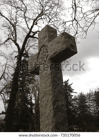Cross tombstone in a graveyard. 