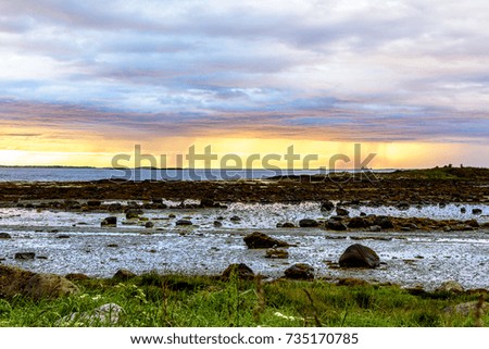 Serene Scandinavian landscape seascape with islands, blue skies and puffy clouds.