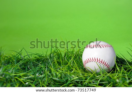 Baseball softball in the grass with green background and copy space