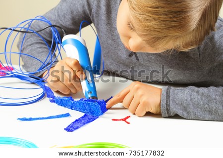 Focused child creating new 3d object with 3d printing pen. Royalty-Free Stock Photo #735177832