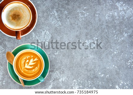 Hot coffee in a white cup on stone table board background.Top view.