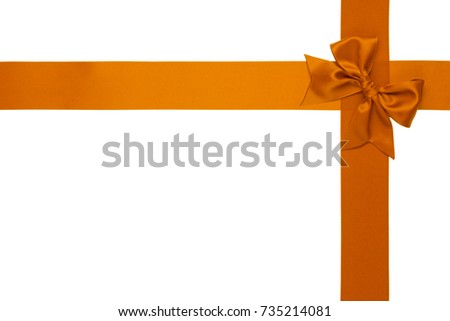Single orange satin gift bow with tails on right with cross two ribbons isolated on white background