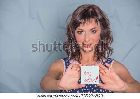 buy now. Beautiful woman showing message BUY NOW .Price Business Buying Finance Investment Concept. Selective focus. Copy space. representing stock market, financial strategies and marketing success