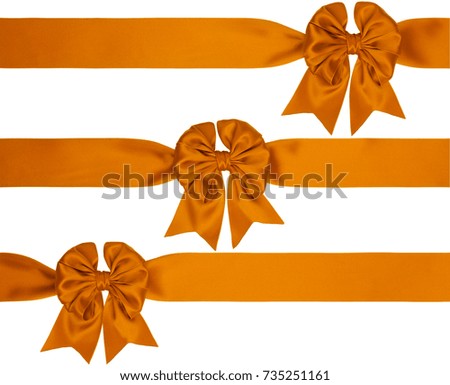 Set of three orange satin bow with tails with three ribbons isolated on white