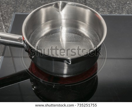 Pan with boiling water on cooker