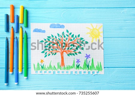 Child's drawing of tree on blue background