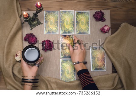 Tarot cards on wooden desk table of fortune teller. Tarot reading. Royalty-Free Stock Photo #735266152