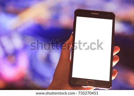 Woman using her Mobile Phone in the street, night light Background , soft focus picture.
