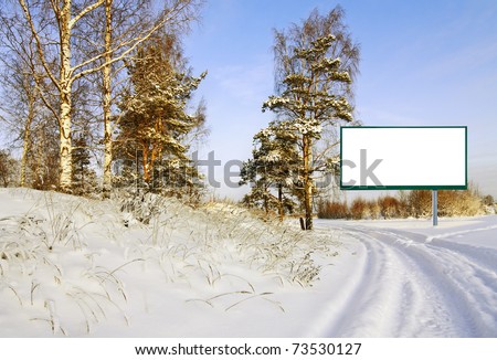 billboard on the road in the winter forest