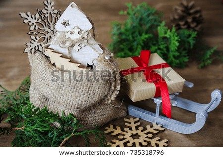 Christmas Composition in Rustic Style. Holidays Background With Wooden Xmas Decoration. Toned image.