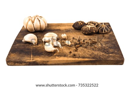 Vegetables, mushrooms and spices on a wooden cutting board Image is isolated And white background.
