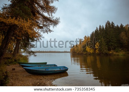 autumn lake boats on the shore