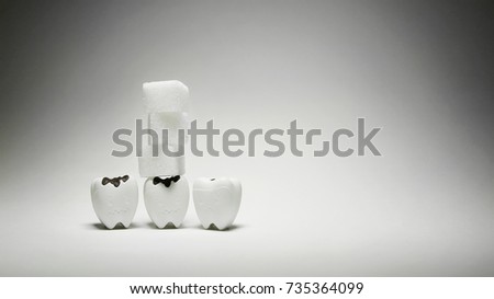 Cubes sugar on decayed tooth model in bad and sad emotion, Warning Dental Healthy 2