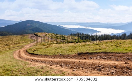 Dirt road in the Carpathian mountains. Ukraine. Royalty-Free Stock Photo #735384802