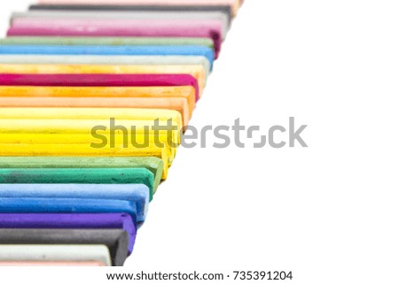 Pastel chalk crayons on a white background