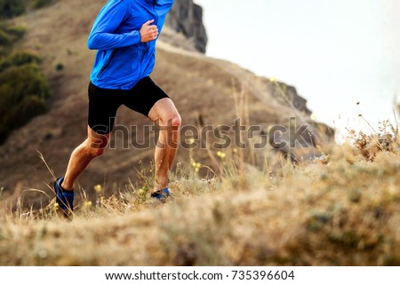 mountain marathon running uphill athlete men runner Royalty-Free Stock Photo #735396604
