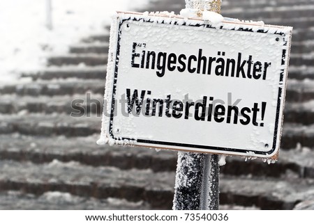 Sign saying reduced winter icy staircase before