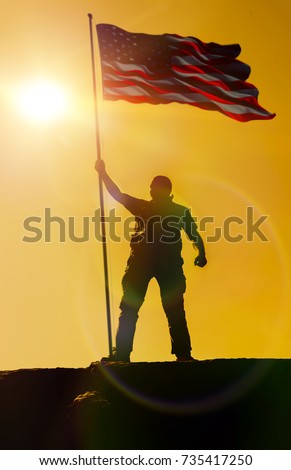 Silhouette of man holding US flag American on the mountain. The concept of Independence Day. a successful silhouette winner, a man waving an American flag on top of a mountain peak