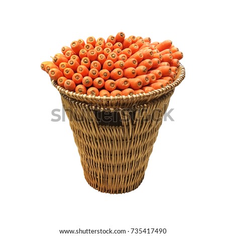 Heap of orange carrots display in bamboo basket isolated on white background.