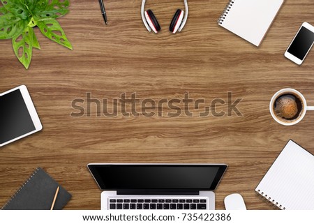 Modern workspace with laptop tablet, smartphone and coffee cup copy space on color background. Top view. Flat lay style.