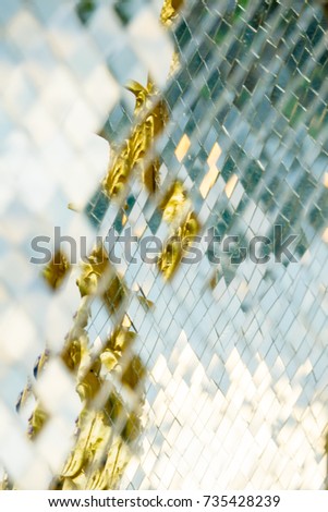 Small mirror decorated on wall background with reflection