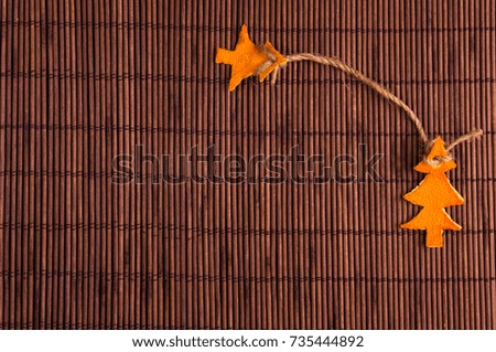 New Year Concept. Christmas decorations hand made from tangerine peel on bamboo mat background