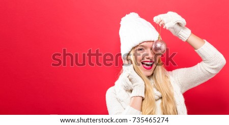 Happy young woman holding a Christmas bauble
